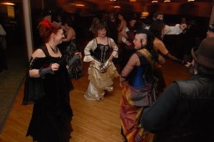 Katie Angel, Kat Alyst, and Madame Belle on the dance floor. Photo by Paul F. P. Pogue of Stargrave Luminography.